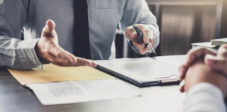 Businessman and Male lawyer or judge consult having team meeting with client, Law and Legal services concept. Qui peut licencier dans un Groupe ?