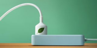 Clean Energy Concept. Close-up of White Power Socket on the table. Green leaf Icon print on Electric Plug. Produce a Green Power. World Earth Day, Sustainable Resources, Environmental Care RSE : vers un renforcement du devoir de vigilance