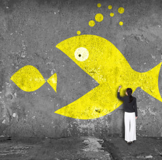 businesswoman drawing big fish eat small fish on the wall; Shutterstock ID 235025512; Ordering Party: CMS Cameron McKenna Nabarro Olswang LLP (Jasmine Welch); Job/Project: thought leadership report; Purchase Order: budget code: SECTOR.00012 La dette dans les opérations de fusion-acquisition : principes généraux et application aux salariés