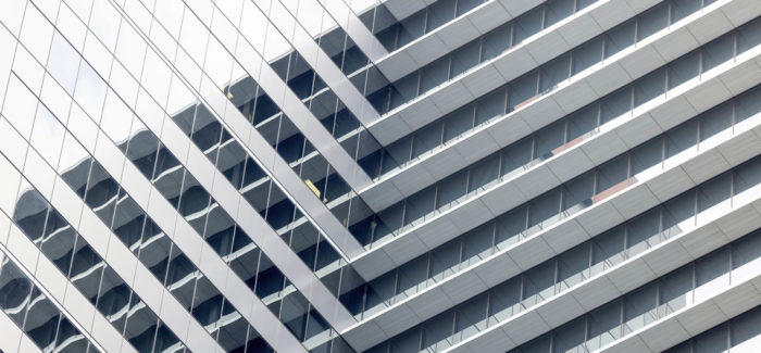 Closeup modern office building, abstract background with copy space, full frame horizontal composition Le partage de la valeur en cas de cession