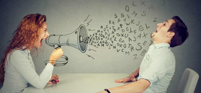 angry young woman with megaphone shouting at stressed scared man blown away by wave of alphabet letters Sanctionner le management toxique : le comportement de l’employeur ne minore pas la faute du salarié