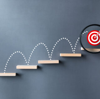 Unlock potential of business success stairs dart and dartboard targets magnifying glass with hand on gray background. Explore opportunities growth embrace steps to achieve ambitions and goal concept. L’Accord de Performance Collective (APC) : un outil juridique puissant, soumis à contrôle judiciaire de réalité